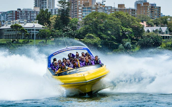 Thunder Jet boat speeding on water with passengers enjoying the ride in Sydney.