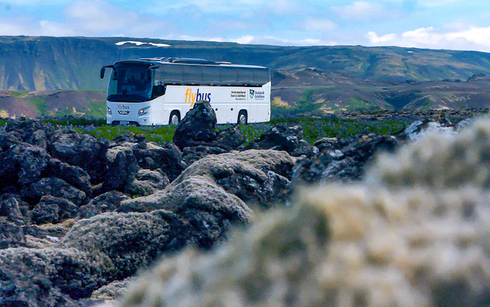 Bus traveling through Icelandic landscape en route to Blue Lagoon.