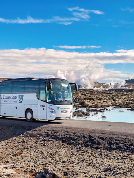 Bus on road near Blue Lagoon geothermal spa in Iceland.