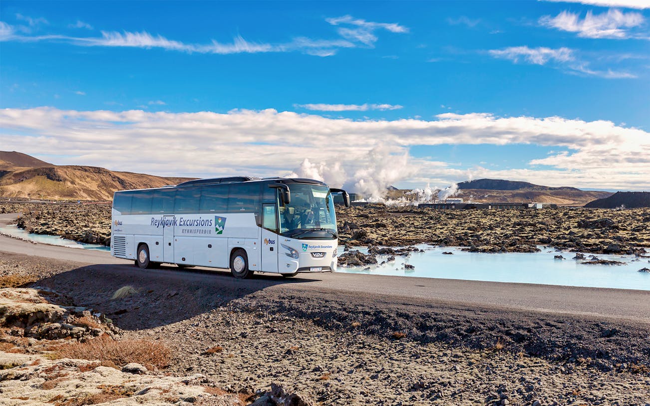 Bus on road near Blue Lagoon geothermal spa in Iceland.