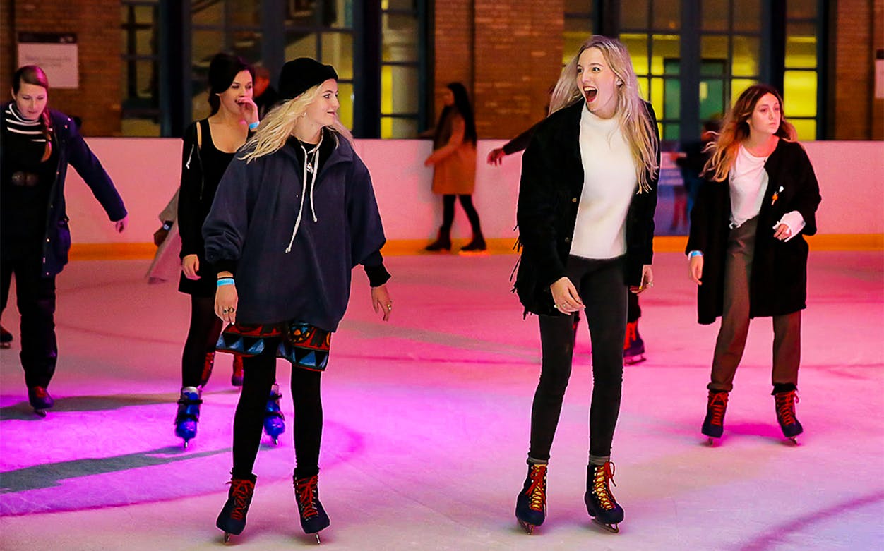 People ice skating at Hyde Park Winter Wonderland in London.
