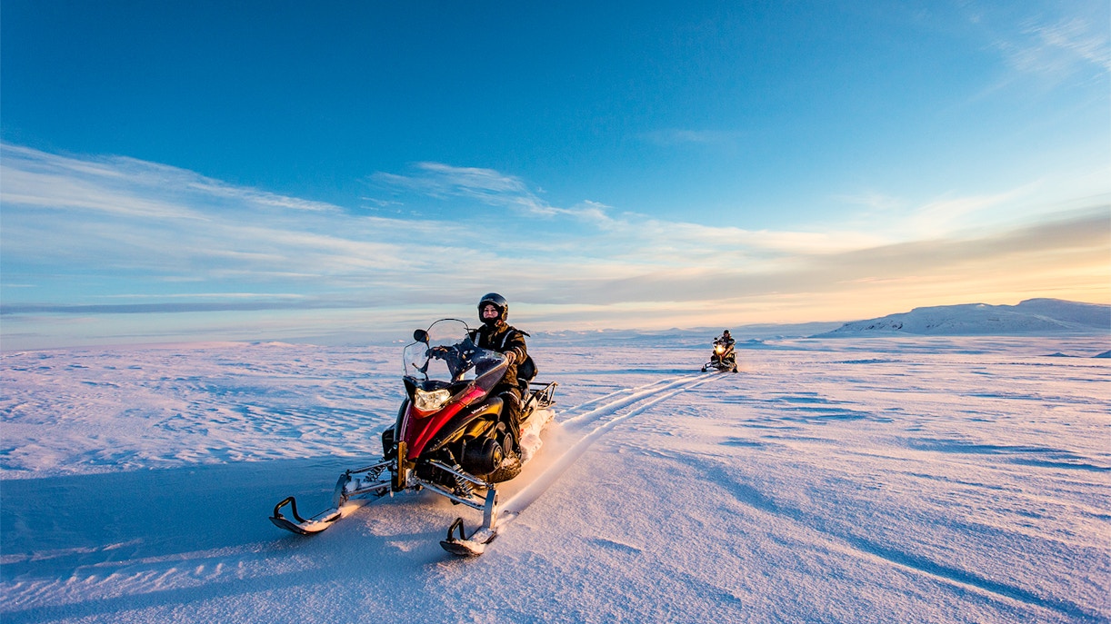 Snowmobiles on snowy terrain during Iceland's Golden Circle tour.