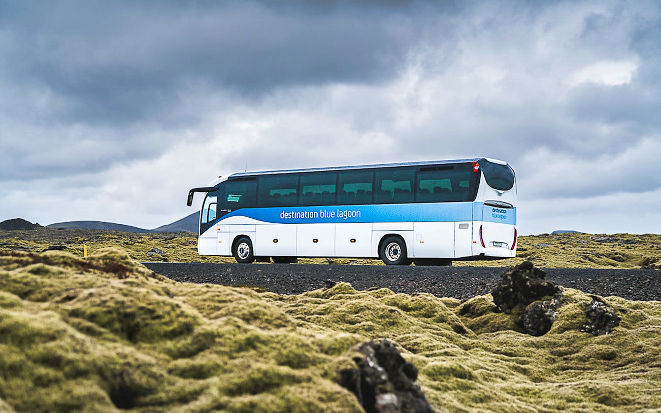 Bus to Blue Lagoon in Icelandic landscape, offering roundtrip transfers from Reykjavik.