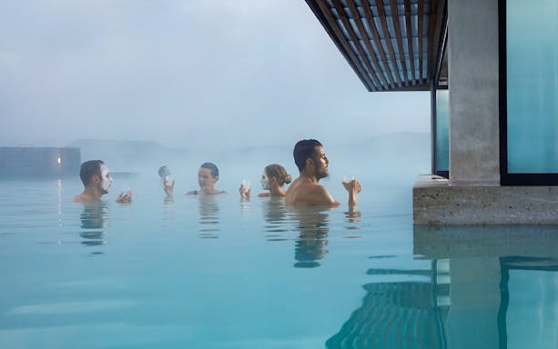 People relaxing in the Blue Lagoon geothermal spa near Reykjavik, Iceland.