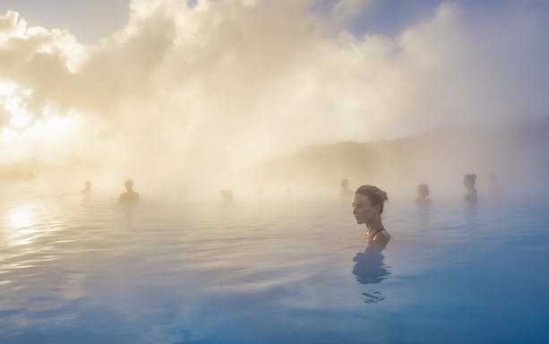 People relaxing in the geothermal waters of the Blue Lagoon, Iceland.