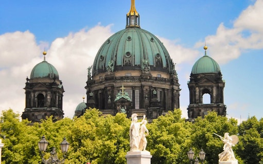 Berlin Cathedral with statues and trees in the foreground on the Reichstag Tour.