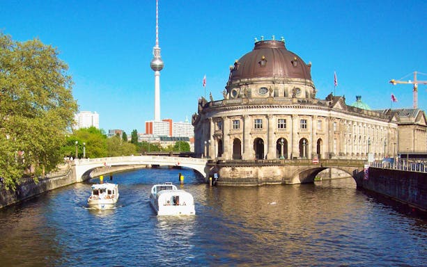 Boats on the Spree River near Berlin's Bode Museum with the TV Tower in the background.