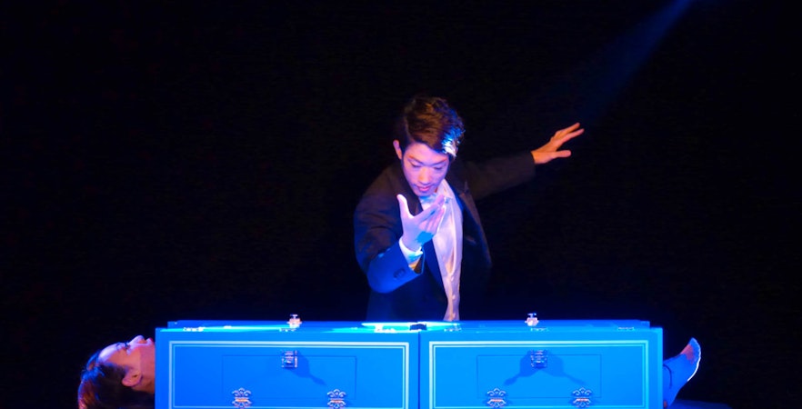 Magic show performer levitating table at The Illusion Museum, MIRAIZA, Osaka.