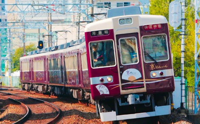 Train on Hankyu line in Osaka, Japan, traveling through urban area.