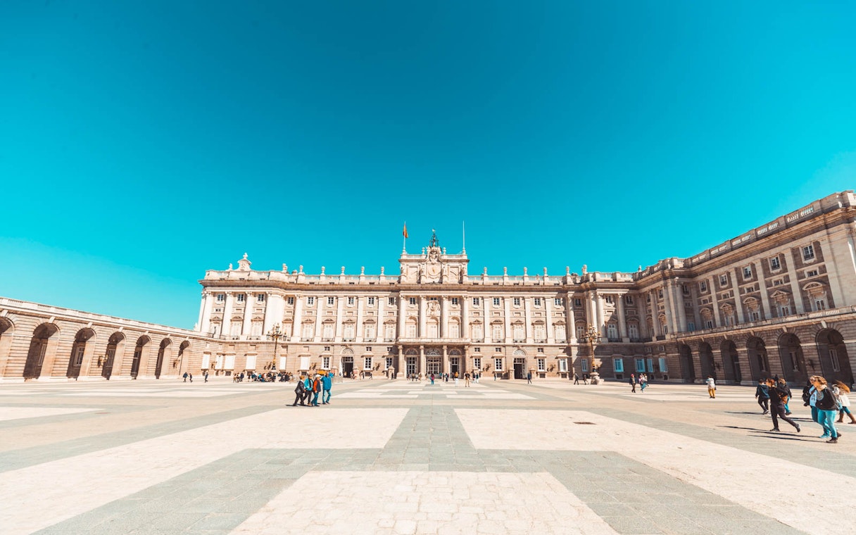 Royal Palace of Madrid courtyard with visitors, highlighting fast track ticket access.