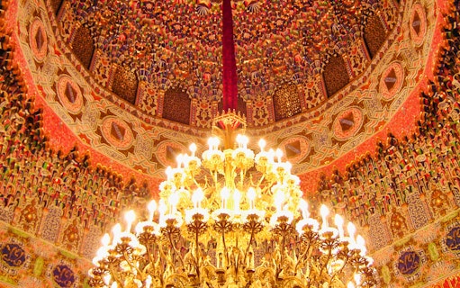 Ornate ceiling and chandelier in the Royal Palace of Aranjuez, Spain.