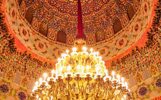 Ornate ceiling and chandelier in the Royal Palace of Aranjuez, Spain.