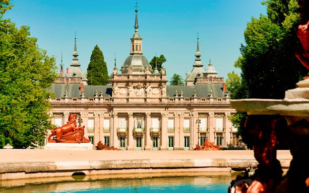 Royal Palace of San Ildefonso with fountain and garden view.