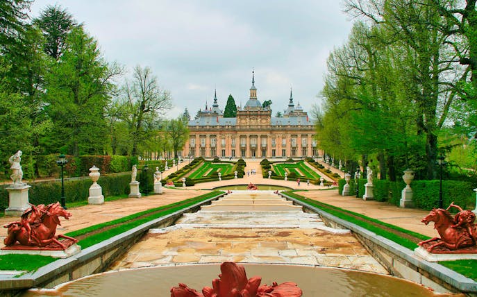 Royal Palace of San Ildefonso with gardens and statues in Segovia, Spain.