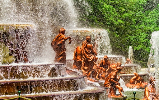 Fountain sculptures at Royal Palace of San Ildefonso, Segovia, with cascading water.