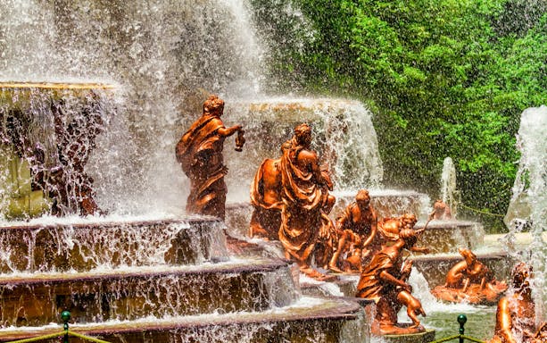 Fountain sculptures at Royal Palace of San Ildefonso, Segovia, with cascading water.