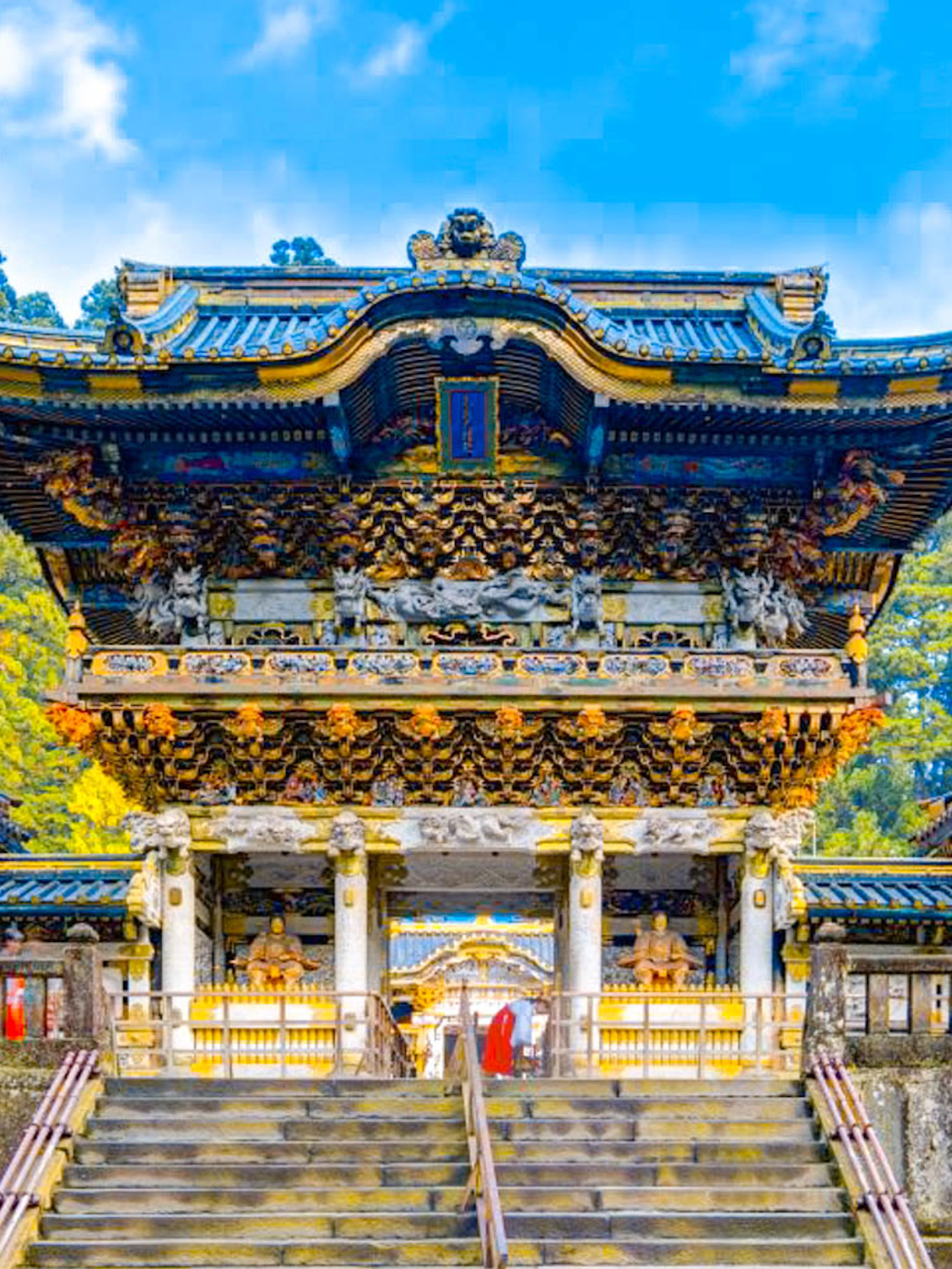 Toshogu Shrine entrance in Nikko, Japan, with ornate carvings and vibrant colors.