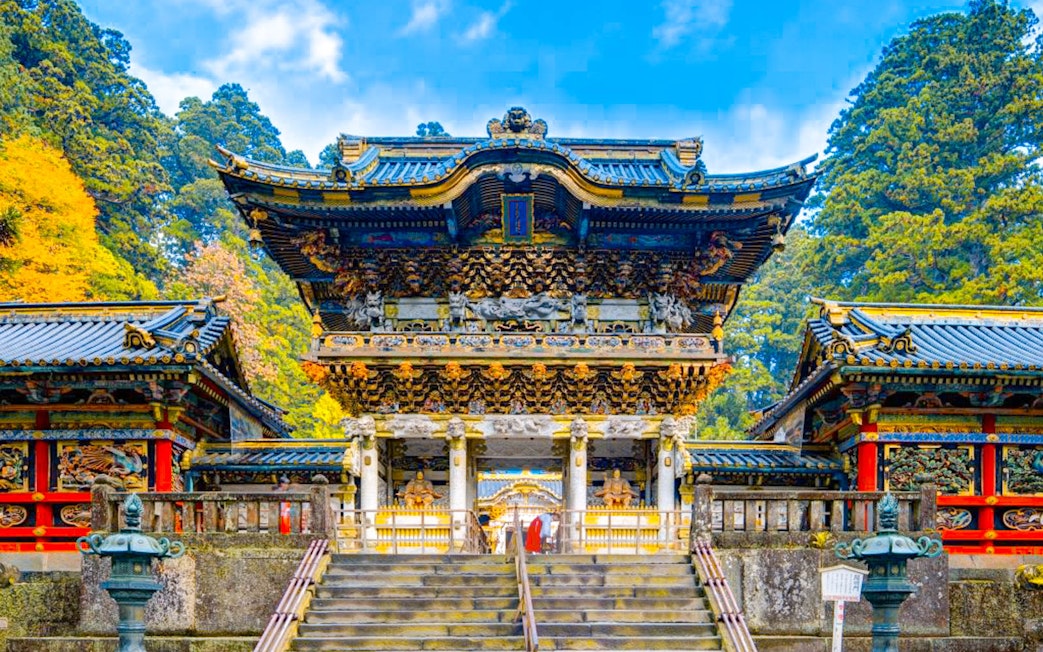 Toshogu Shrine entrance in Nikko, Japan, with ornate carvings and vibrant colors.