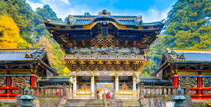 Toshogu Shrine entrance in Nikko, Japan, with ornate carvings and vibrant colors.