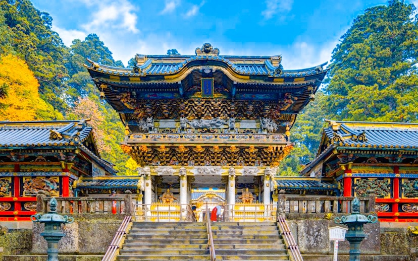 Toshogu Shrine entrance in Nikko, Japan, with ornate carvings and vibrant colors.