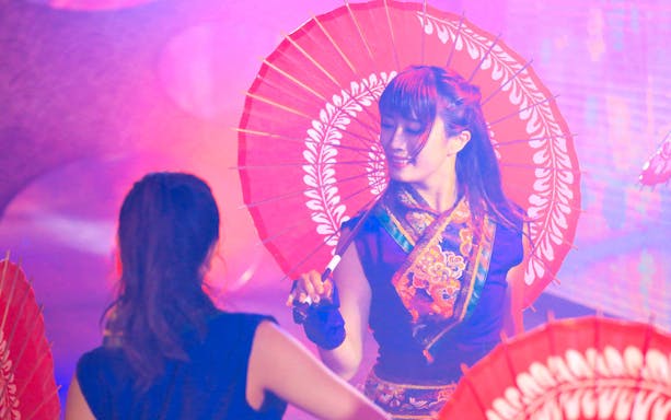 Performer with red parasol at Roppongi KAGUWA Entertainment Show, Tokyo.