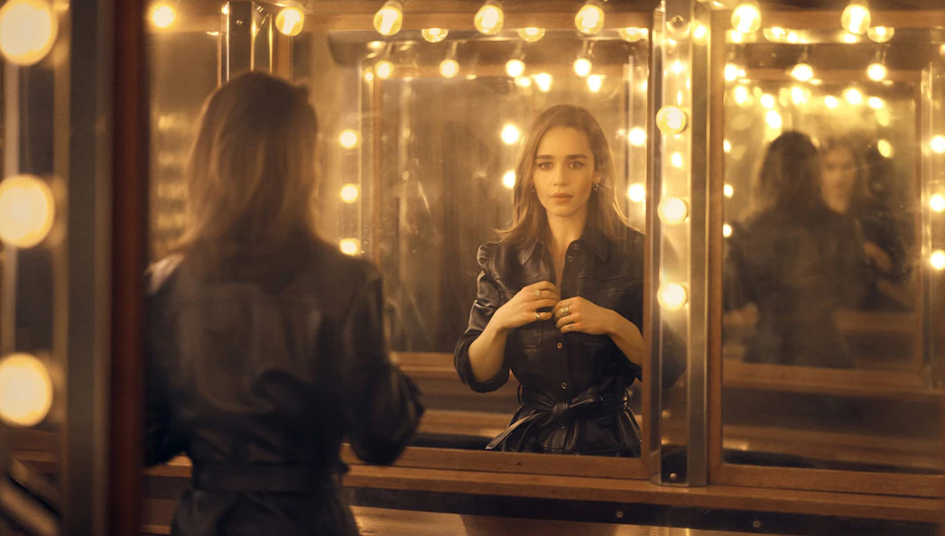 Actress in a dressing room with mirror reflections, preparing for "The Seagull" performance.