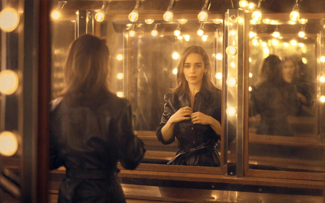 Actress in a dressing room with mirror reflections, preparing for "The Seagull" performance.