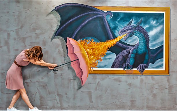 Person interacting with dragon art at 3D World Dubai Trick-Art ‘Selfie’ Museum.
