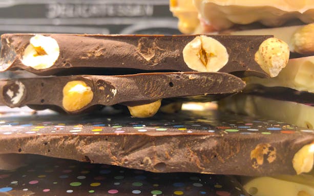 Stacked chocolate bars with hazelnuts, part of a chocolate tasting in Venice.