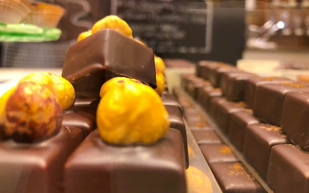Chocolates with hazelnuts on display for tasting in a Venice shop.