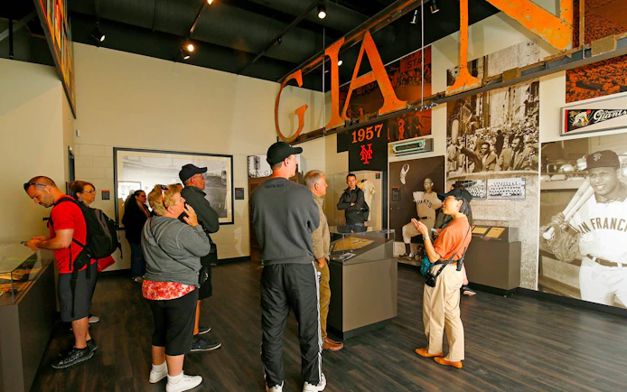 Visitors exploring San Francisco Giants memorabilia at Oracle Park museum.