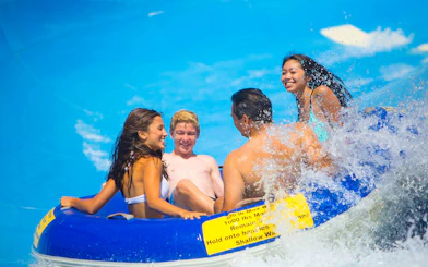 Group enjoying a water ride on a raft, part of San Francisco Explorer Pass attractions.