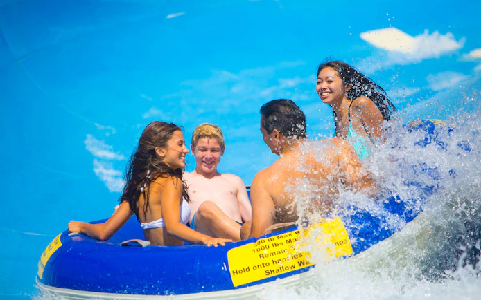Group enjoying a water ride on a raft, part of San Francisco Explorer Pass attractions.