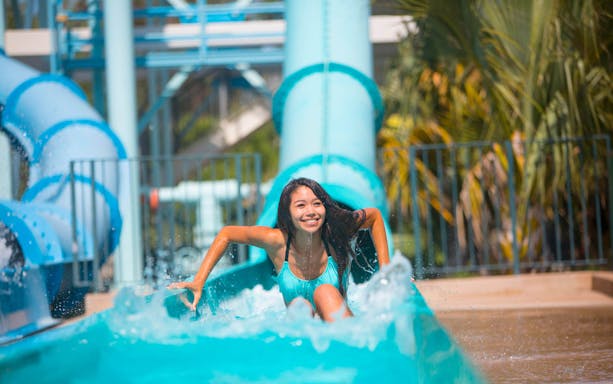 Person enjoying a water slide at a San Francisco amusement park.