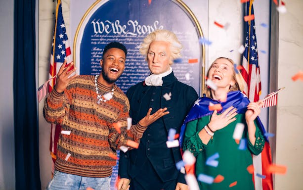 Visitors enjoying a wax museum in Washington DC with historical figures.