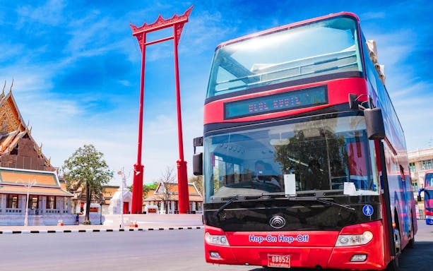 Hop-on-hop-off bus near Giant Swing in Bangkok, part of Elephant GOGO tour.