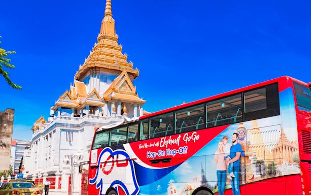 Hop-on-hop-off bus near Wat Traimit Temple, Bangkok.