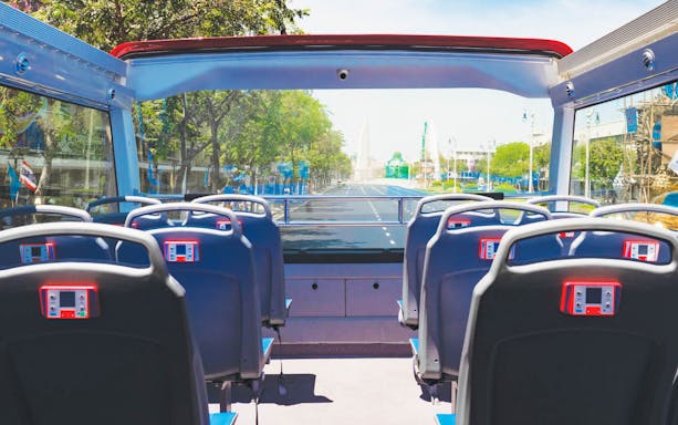 Open-top bus interior on Bangkok street, part of Elephant GOGO Hop-On-Hop-Off Tour.