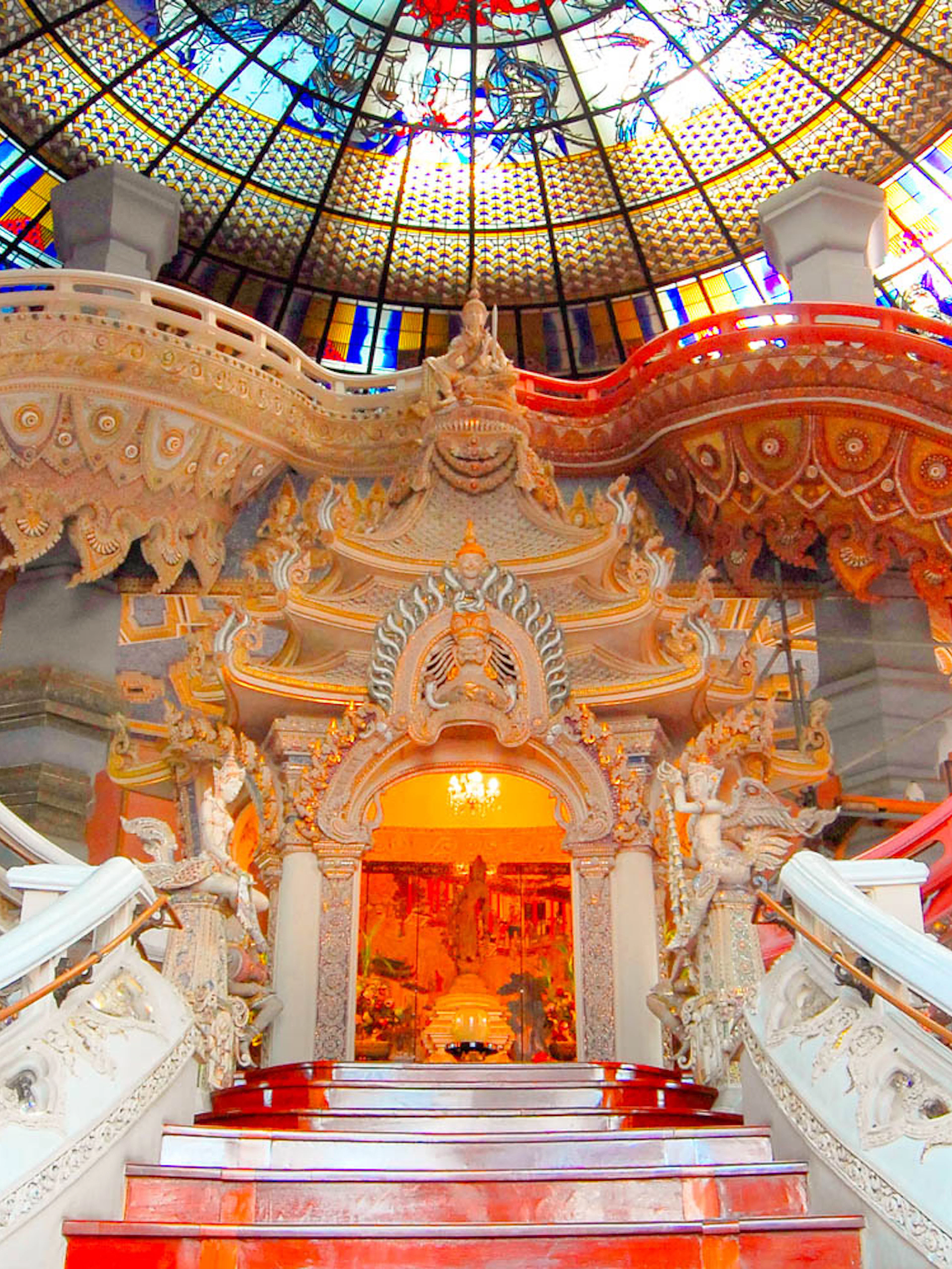 Erawan Museum interior with ornate staircase and stained glass ceiling, Bangkok, Thailand.