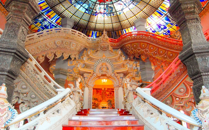 Erawan Museum interior with ornate staircase and stained glass ceiling, Bangkok, Thailand.