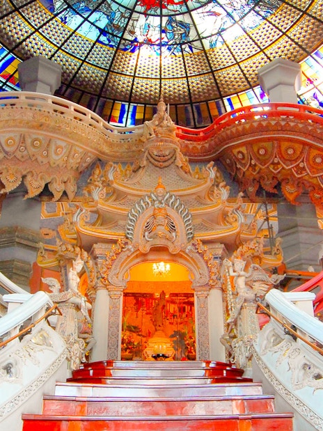 Erawan Museum interior with ornate staircase and stained glass ceiling, Bangkok, Thailand.