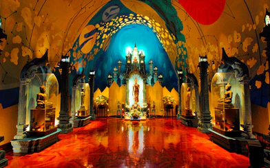 Erawan Museum interior with ornate statues and vibrant ceiling art.