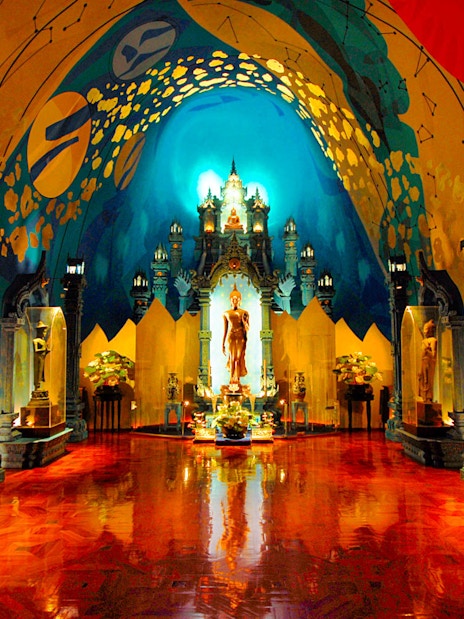 Erawan Museum interior with ornate statues and vibrant ceiling art.
