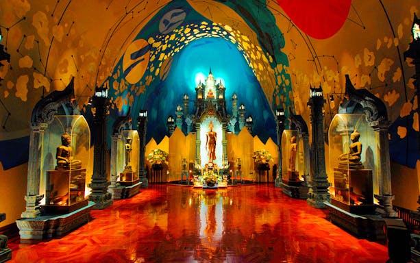 Erawan Museum interior with ornate statues and vibrant ceiling art.