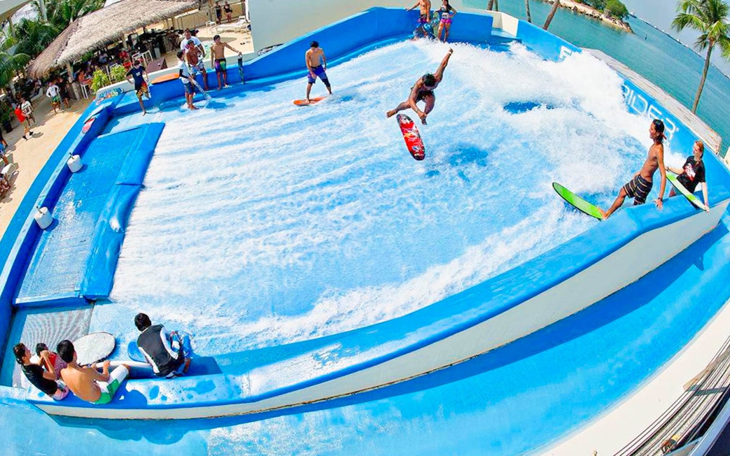 Surfers enjoying artificial wave at Flow House Bangkok.