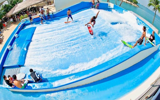 Surfers enjoying artificial wave at Flow House Bangkok.