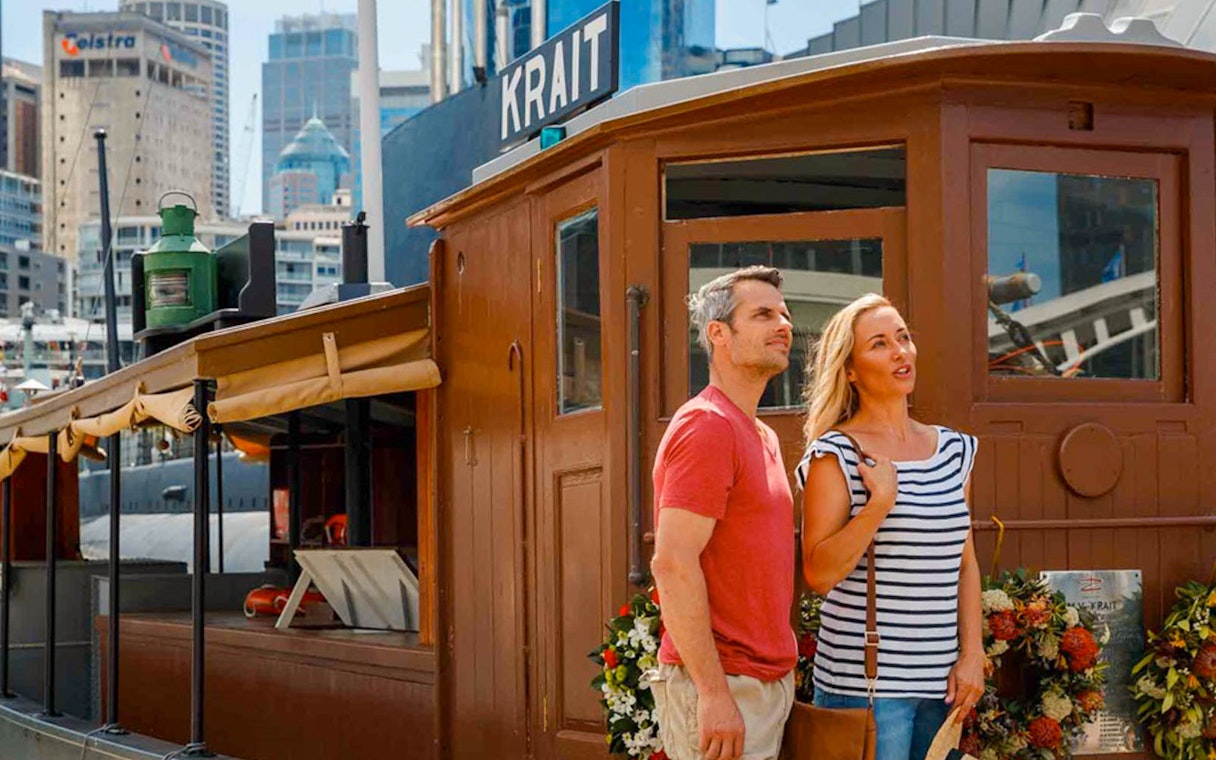 Couple exploring the Krait vessel at the Australian National Maritime Museum, Sydney.