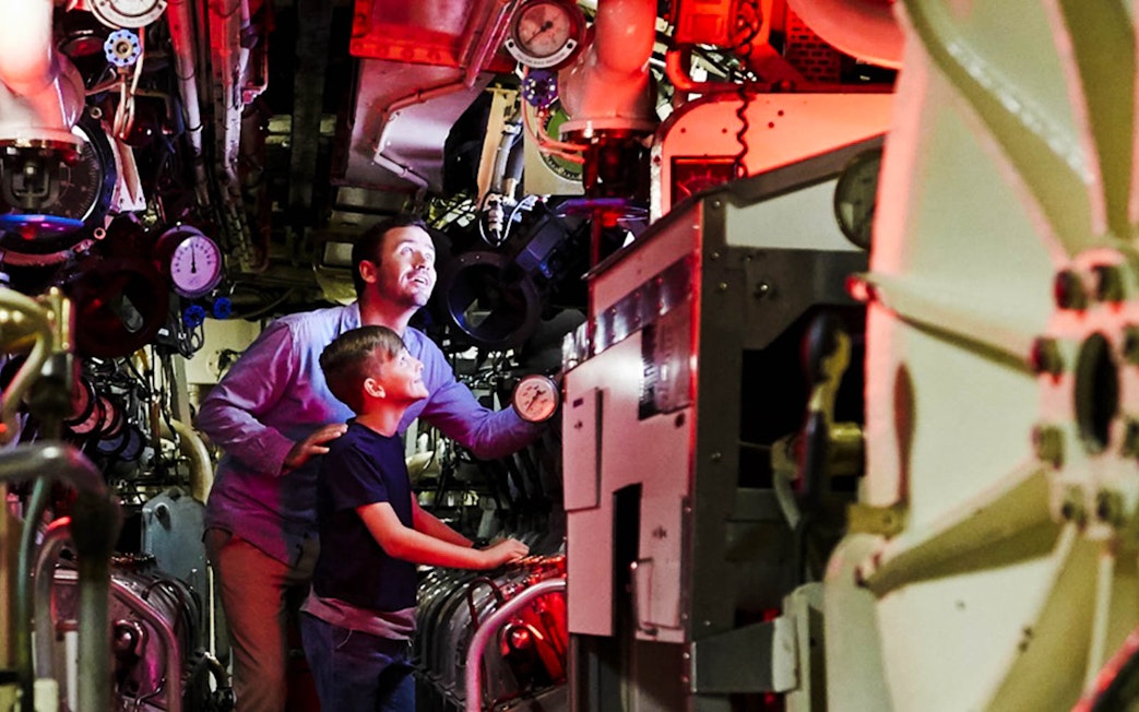 Visitors exploring submarine interior at Australian National Maritime Museum, Sydney.