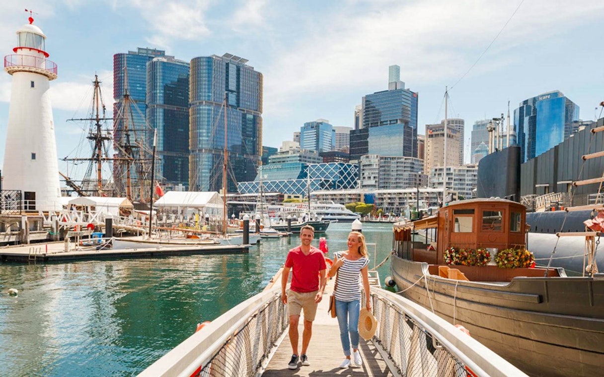 Visitors walking near ships at Australian National Maritime Museum, Sydney.