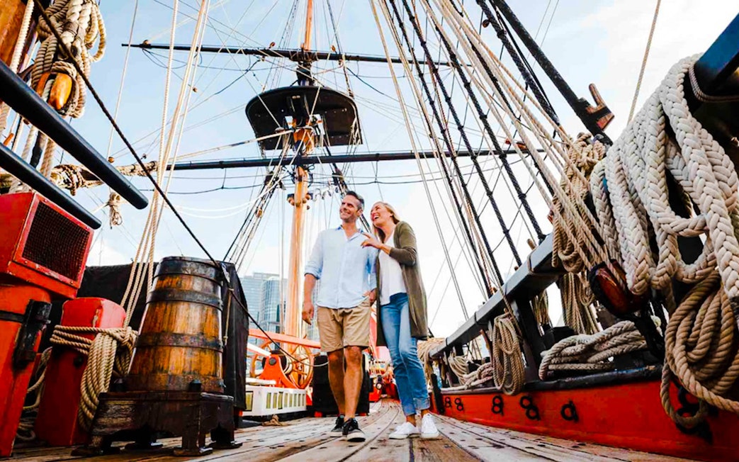Couple exploring historic ship at Australian National Maritime Museum, Sydney.